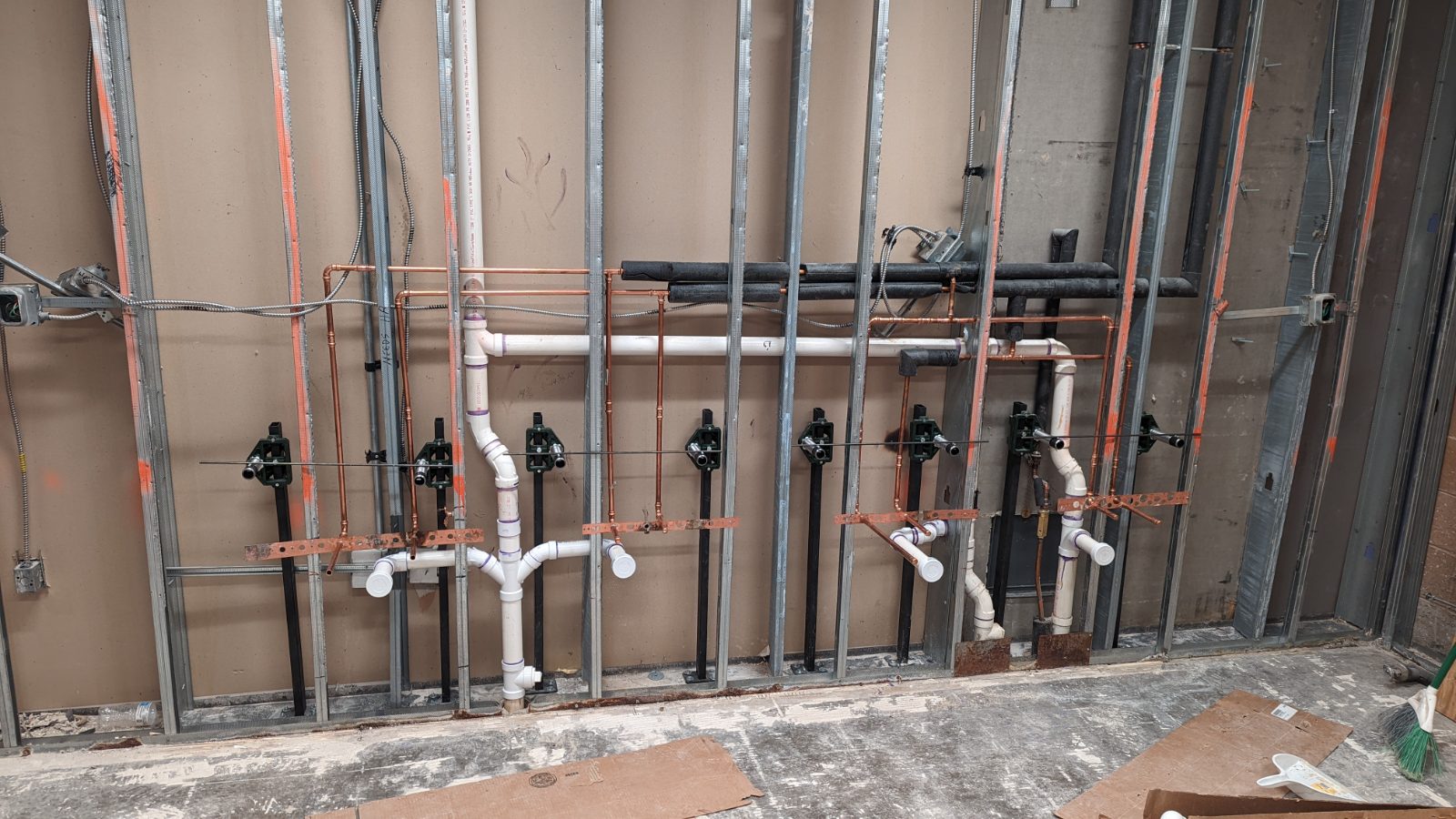 Plumbing rough-in — copper supply and PVC waste in a stud wall
